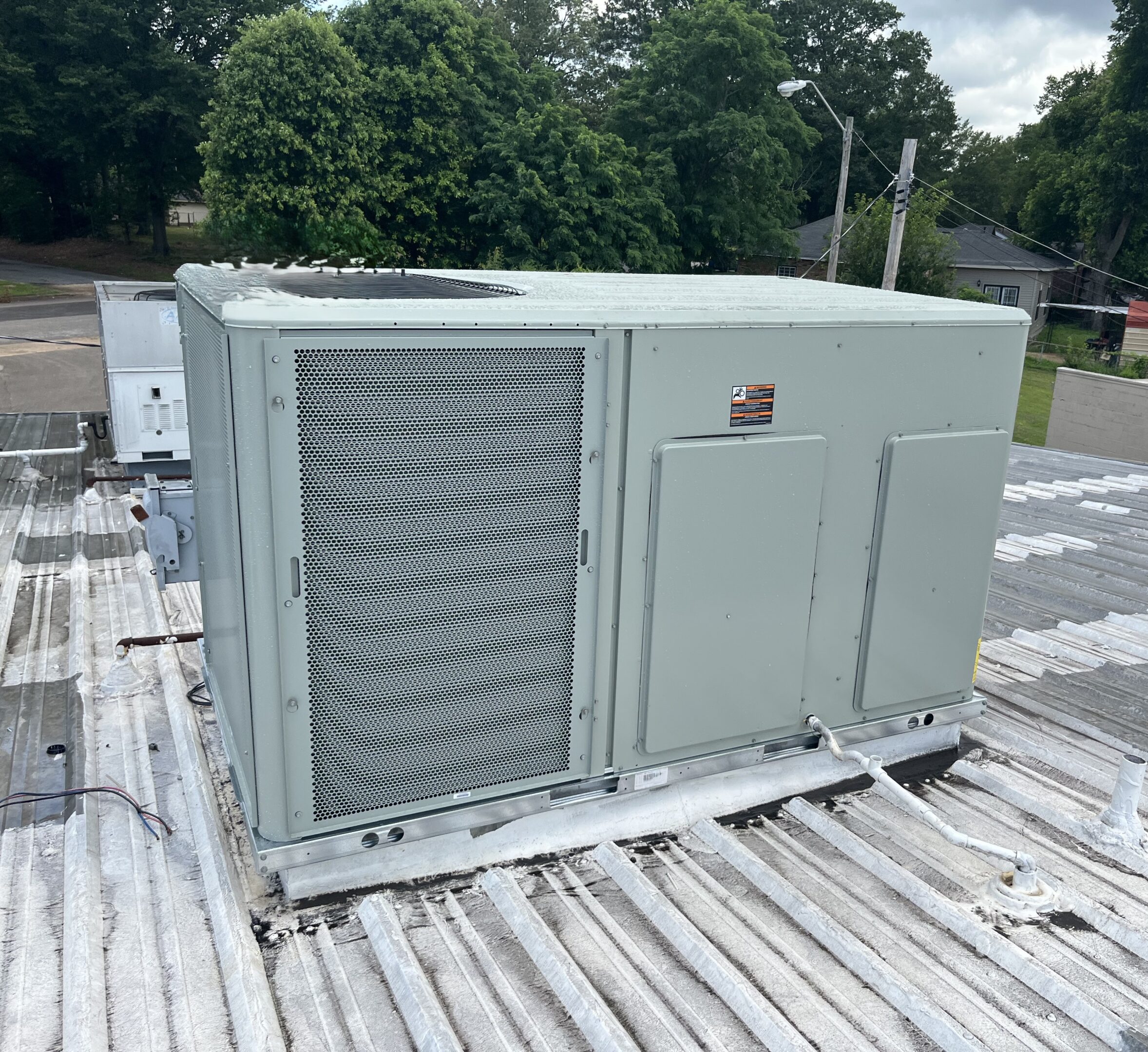 Rooftop commercial HVAC unit on metal roof