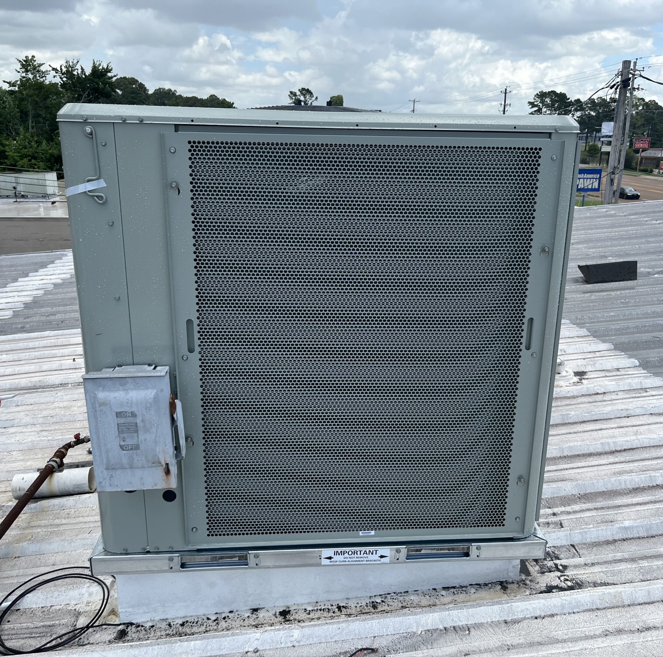 Rooftop commercial HVAC unit on metal roof