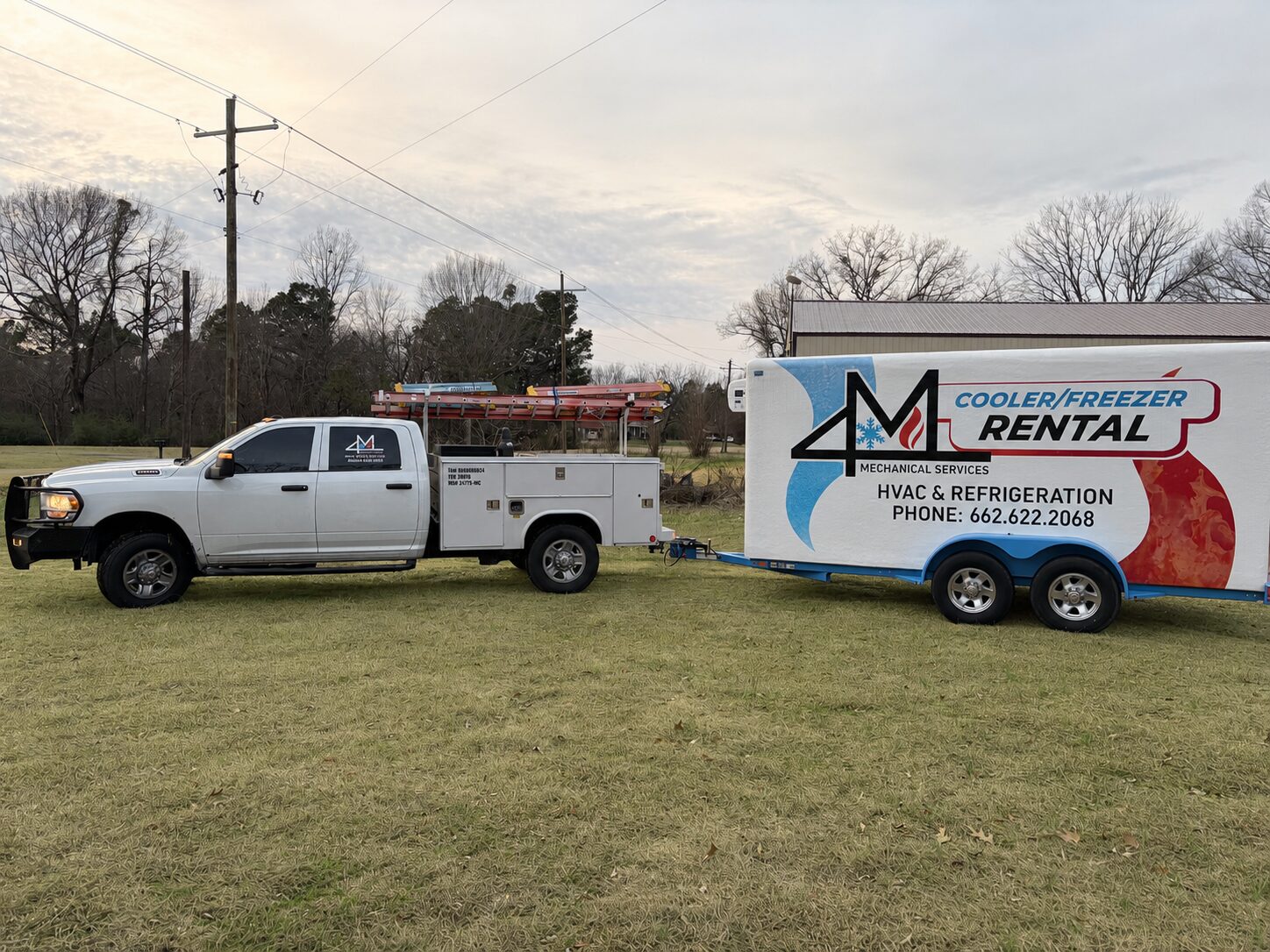 White service truck towing HVAC rental trailer