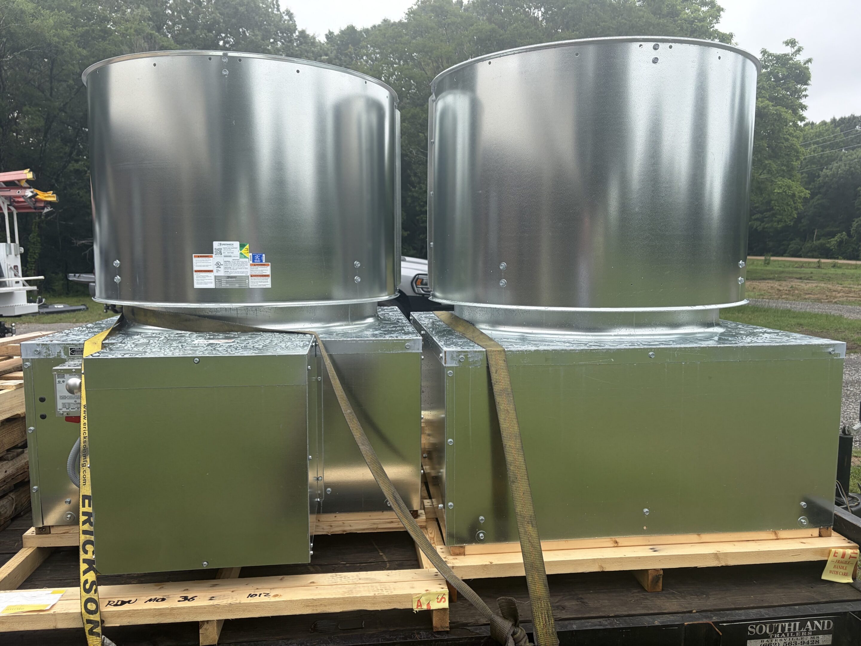 Two large galvanized industrial rooftop exhaust fans