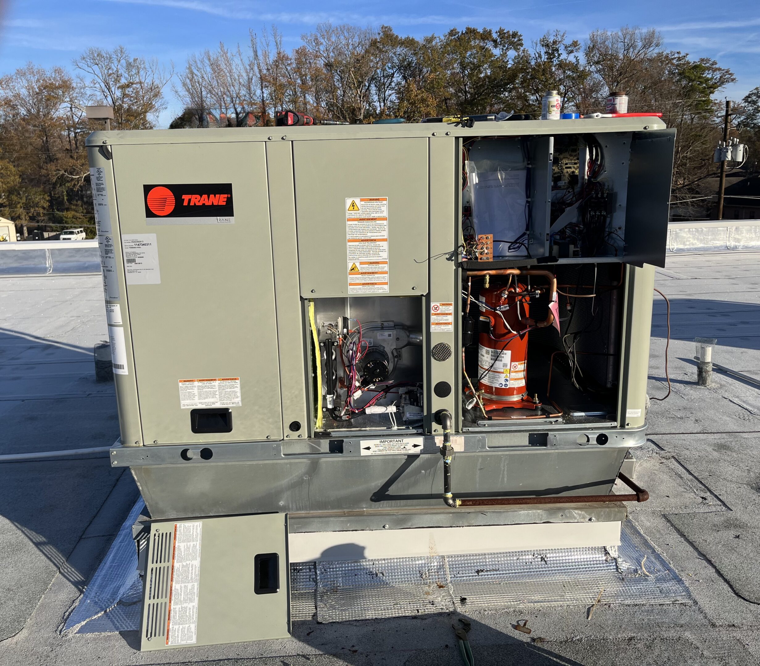 Rooftop Trane HVAC unit with open panels