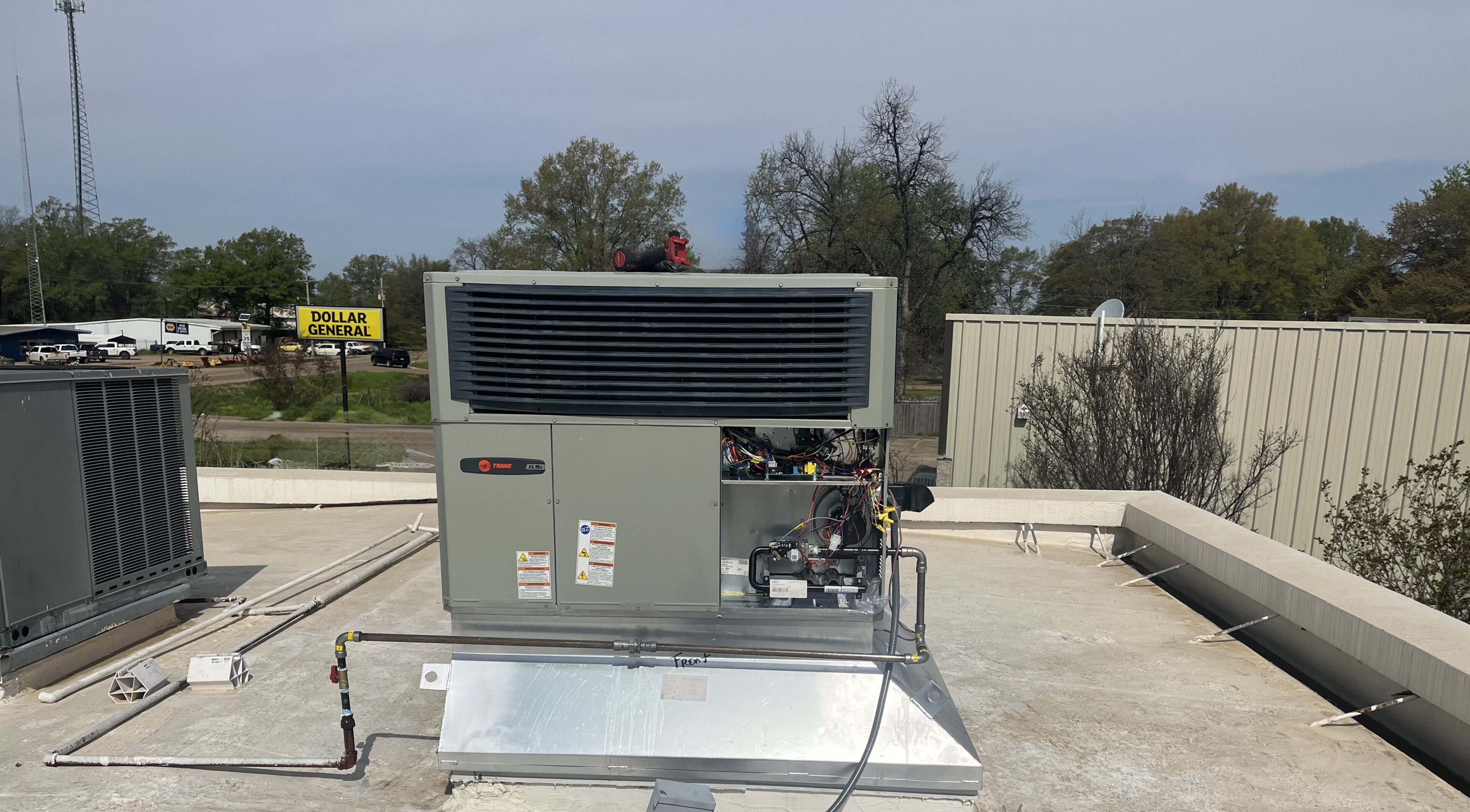Rooftop commercial HVAC unit with open panel