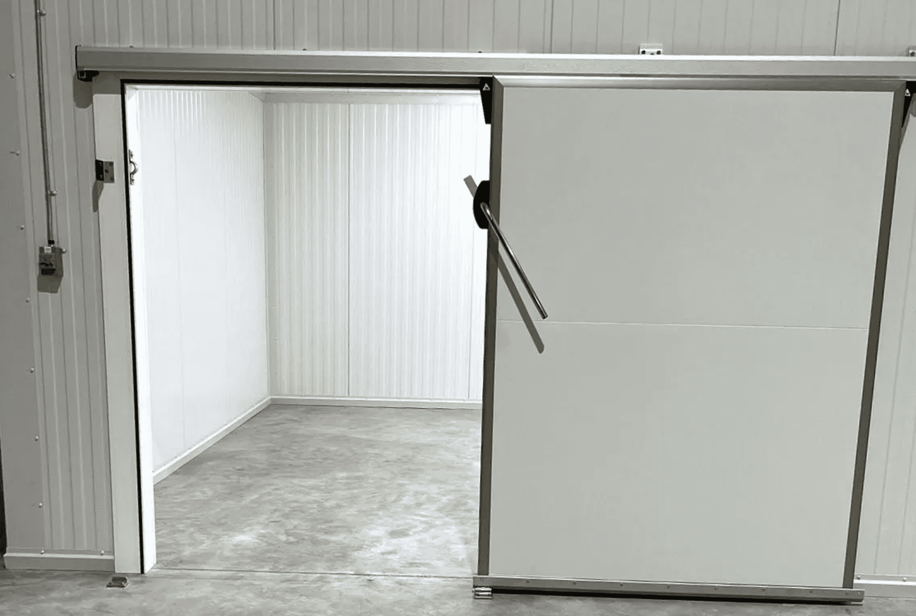 Empty walk-in freezer with open sliding door