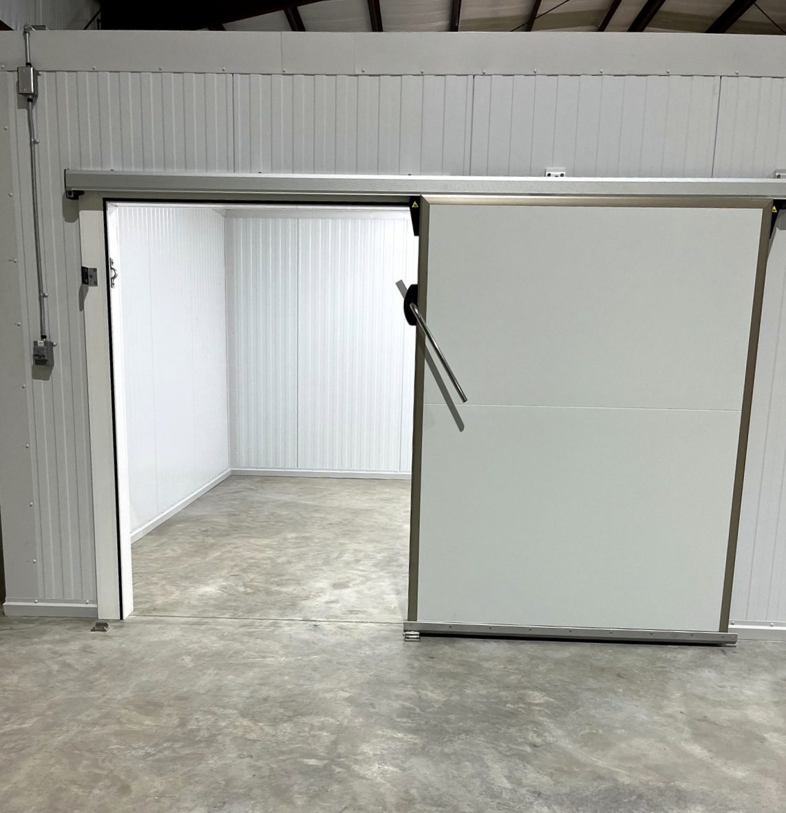 Open industrial sliding cold storage room door